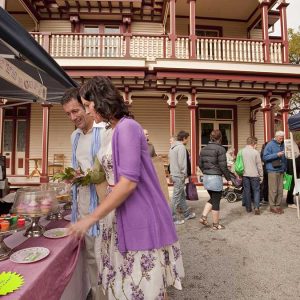 Couple sampling wares at the Farmers Market in Christchurch. Copyright: christchurchnz.com